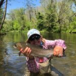 2021 - Mona Brewer with a a beautiful rainbow Trout, caught on the Davidson River in NC.
